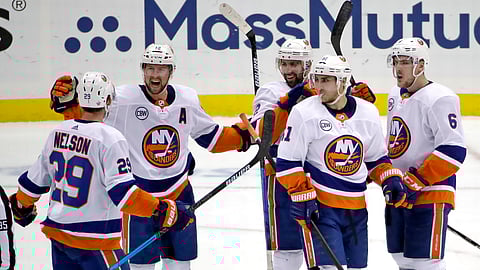 The Islanders’ Josh Bailey (12) celebrates his empty-net goal against the Penguins. The Islanders won 3-1, sweeping the series. (AP Photo/Gene J. Puskar)