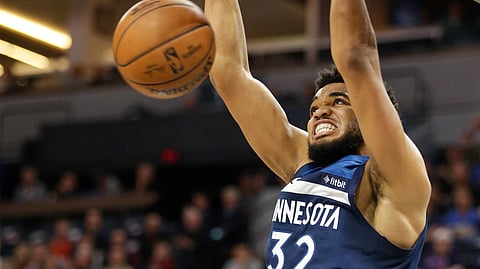 Minnesota Timberwolves center Karl-Anthony Towns dunks during the first half of a NBA basketball game against the Oklahoma City Thunder on April 7, 2019.