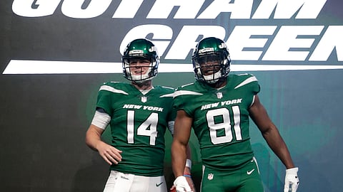 New York Jets quarterback Sam Darnold (14) and wide receiver Quincy Enunwa (81) model the NFL football team’s new “Gotham green” uniforms on April 4, 2019.
