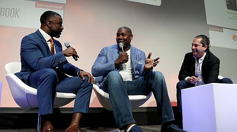 Former Philadelphia Eagles NFL football running back Brian Westbrook, left, talks with former Philadelphia Phillies baseball first baseman Ryan Howard, center, and Wayne Kimmel, partner at SeventySix Capital, during a panel talking about the move from professional athlete to entrepreneur at the Betting On Sports America conference on April 24, 2019.