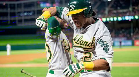 Oakland Athletics’ Khris Davis (2) celebrates with Jurickson Profar after hitting a solo home run off Texas Rangers relief pitcher Chris Martin earlier this season. The A's have announced plans for a data-driven audio broadcast of Thursday's game against the Rangers. (AP File Photo/Jeffrey McWhorter)