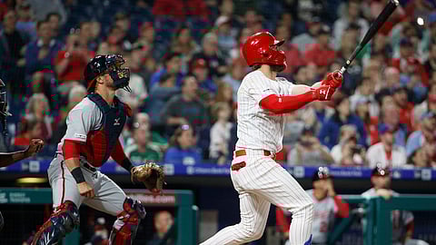Phillies’ Bryce Harper and Nationals catcher Yan Gomes (left) watch Harper’s three-run home run Tuesday (Chris Szagola)