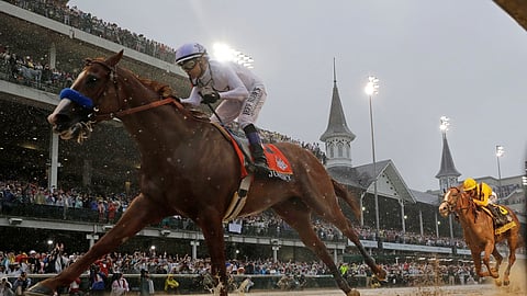 In this May 5, 2018, file photo, Mike Smith rides Justify to victory during the 144th running of the Kentucky Derby horse race at Churchill Downs in Louisville, Ky.