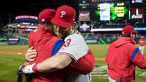 Phillies manger Gabe Kapler (left_ gets hugged by Bryce Harper after Tuesday’s game (Alex Brandon)