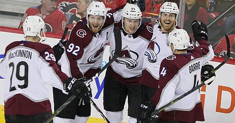 Nathan MacKinnon (left) and his Avalanche friends celebrate a goal in Game 5 against the Flames on April 19 (Dave Chidley/The Canadian Press)