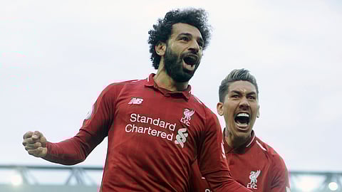 Liverpool’s Mohamed Salah, left, and Roberto Firmino celebrate after Tottenham scored an own goal, Sunday, March 31, 2019. (AP Photo/Rui Vieira)