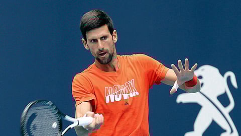 In this March 18, 2019, file photo, Novak Djokovic hits during a practice round for the Miami Open tennis tournament at Hard Rock Stadium in Miami Gardens, Fla.