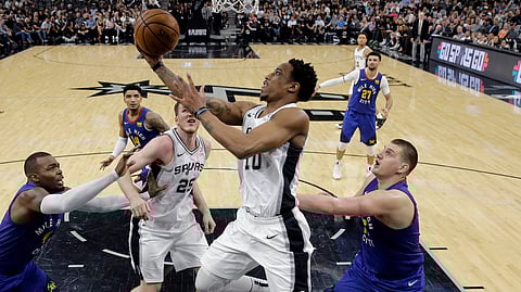 Spurs guard DeMar DeRozan drives to the basket against the Nuggets in Game 6 on April 25 (Eric Gay)