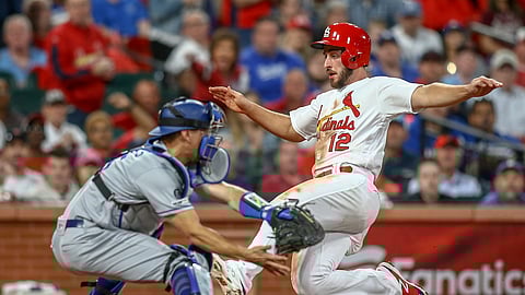 St. Louis Cardinals’ Paul DeJong slides home to score next to Los Angeles Dodgers catcher Austin Barnes during the third inning of a baseball game on April 9, 2019.