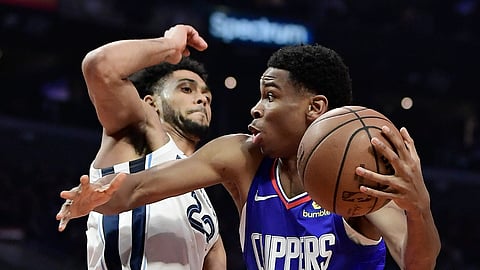Los Angeles Clippers guard Shai Gilgeous-Alexander, right, passes as Memphis Grizzlies guard Tyler Dorsey defends during the game on March 31, 2019.
