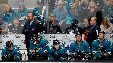 San Jose Sharks coach Peter DeBoer, left rear, stands in the bench area during the second period against the Vegas Golden Knights in Game 2 of an NHL hockey first-round playoff series on April 12, 2019.