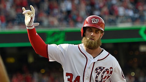 Bryce Harper gestures after one of his 186 career home runs as a Washington National last April (Nick Wass)