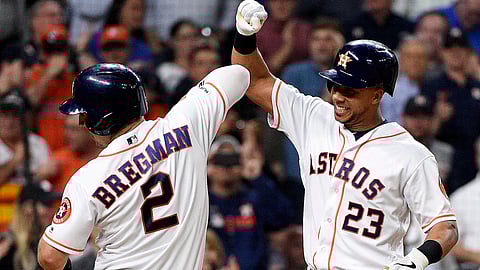 Houston Astros’ Michael Brantley (23) celebrates his two-run home run off Minnesota Twins starting pitcher Kohl Stewart with Alex Bregman during the third inning of a baseball game, Wednesday, April 24, 2019, in Houston. (AP Photo/Eric Christian Smith)