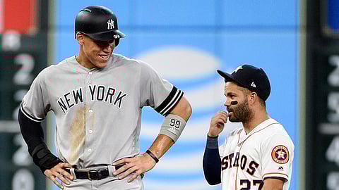 New York Yankees’ Aaron Judge, left, talks with Houston Astros second baseman Jose Altuve during the seventh inning of a baseball game on April 8, 2019.