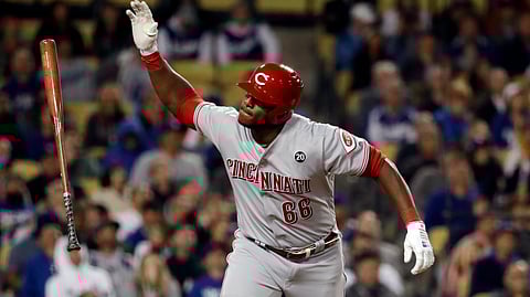 Cincinnati Reds’ Yasiel Puig tosses his bat after popping out during the fifth inning of the team’s baseball game against the Los Angeles Dodgers on April 16, 2019.