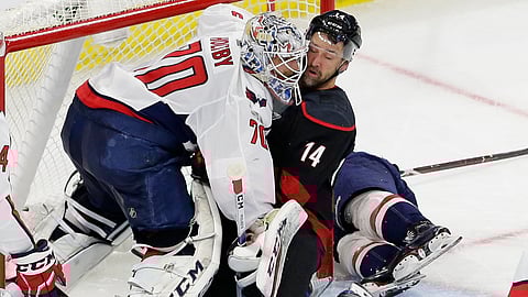 Carolina Hurricanes’ Justin Williams (14) collides with Washington Capitals goalie Braden Holtby (70) during the second period of Game 6 of an NHL hockey first-round playoff series on April 22, 2019.