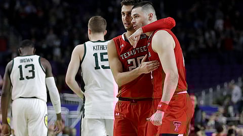 Texas Tech’s Davide Moretti (25) and Matt Mooney celebrate after defeating Michigan State Saturday (David J. Phillip)
