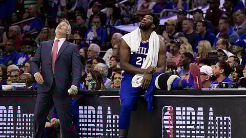 76ers coach Brett Brown and Joel Embiid look up at the scoreboard during Game 1 against the Nets. The score did not look any better up there. (AP Photo/Chris Szagola)