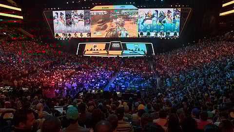 FILE - In this July 28, 2018, file photo, fans watch the competition between the Philadelphia Fusion and the London Spitfire during the Overwatch League Grand Finals, at Barclays Center in Brooklyn. (AP Photo/Mary Altaffer, File)