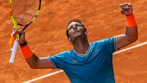 Rafael Nadal, from Spain, celebrates after winning Felix Auger-Aliassime, from Canada, during the Mutua Madrid Open tennis tournament on May 8, 2019.