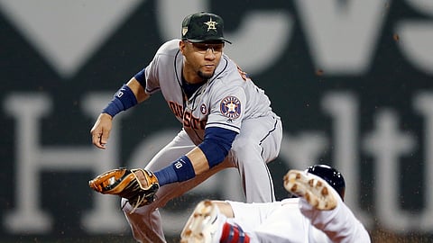 Houston Astros’ Yuli Gurriel, top, tags out Boston Red Sox’s Michael Chavis at second base during the fourth inning of a baseball game ion May 18, 2019.