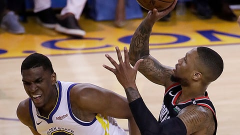 Trail Blazers guard Damian Lillard shoots over Warriors center Kevon Looney in Game 1 on May 14 (Jeff Chiu)in 