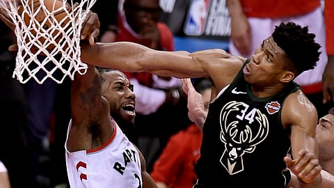 Bucks forward Giannis Antetokounmpo (34) blocks a dunk attempt by Raptors forward Kawhi Leonard in Game 6 on May 25 (Frank Gunn/The Canadian Press)
