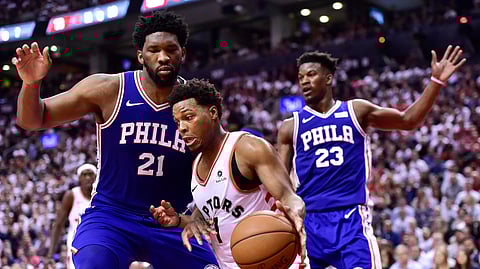 Toronto Raptors guard Kyle Lowry drives around Philadelphia 76ers center Joel Embiid during second-half, second-round NBA basketball playoff action on April 29, 2019.