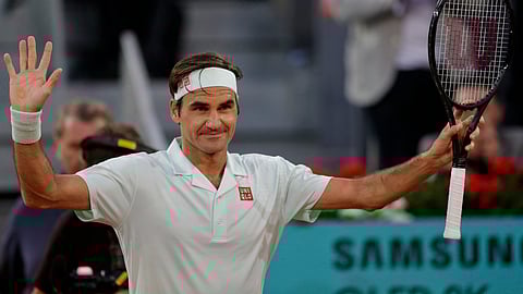 Roger Federer, from Switzerland, celebrates after winning right, embraces Richard Gasquet, from France, during the Madrid Open tennis tournament on May 7, 2019.