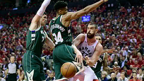 Toronto Raptors center Marc Gasol moves the ball pass Milwaukee Bucks forward Giannis Antetokounmpo during the second half of Game 4 of the Eastern Conference finals on May 21, 2019.