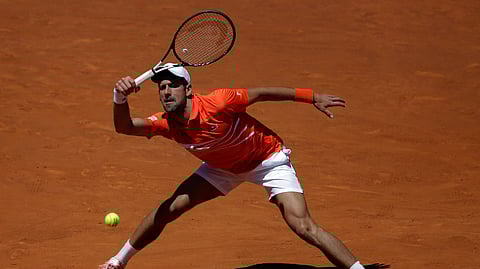Novak Djokovic, of Serbia, returns the ball during his match against Jeremy Chardy, of France, during the Madrid Open tennis tournament on May 9, 2019. 
