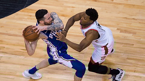 Philadelphia 76ers guard JJ Redick keeps the ball from Toronto Raptors guard Kyle Lowry during Game 5 of the NBA basketball second-round playoff series on May 7, 2019.
