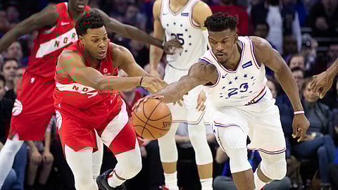 Sixers’ Jimmy Butler (right) and Raptors’ Kyle Lowry battle for a loose ball in Game 4 on May 5 (Chris Szagola)