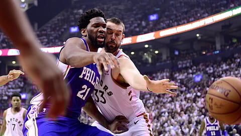 Philadelphia 76ers center Joel Embiid and Toronto Raptors center Marc Gasol watch the ball get away during the first half of Game 5 of an NBA basketball second-round playoff series on May 7, 2019.