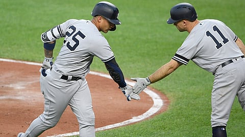 Yankees’ Gleyber Torres (left) celebrates his home run with third base coach Phil Nevin on  May 22 (Nick Wass)