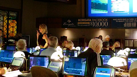 This June 14, 2018 photo shows bettors waiting to make wagers on sporting events at the Borgata casino in Atlantic City hours after it began accepting sports bets. 