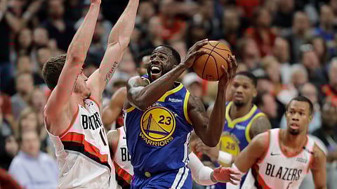 Golden State Warriors forward Draymond Green (23) shoots against Portland Trail Blazers forward Meyers Leonard, left, during the first half of Game 3 of the NBA basketball playoffs Western Conference finals, Saturday, May 18, 2019, in Portland, Ore. (AP Photo/Ted S. Warren)