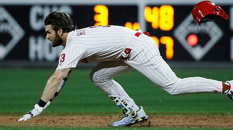 Phillies’ Bryce Harper dives to second base after hitting a double on May 28 (Matt Rourke)