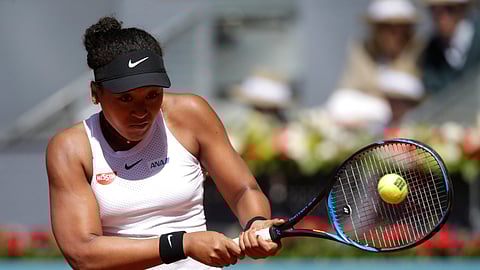 Japan’s Naomi Osaka returns the ball during her match against Slovakia’s Dominika Cibulkova during the Madrid Open tennis tournament, Sunday, May 5, 2019, in Madrid, Spain. (AP Photo/Andrea Comas)