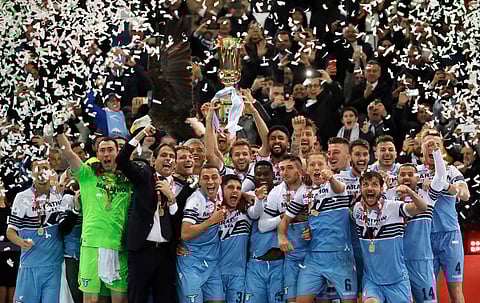 Lazio’s Senad Lulic holds up the Italian Cup trophy at the end of the final match between Lazio and Atalanta, at the Rome Olympic stadium, Wednesday, May 15, 2019. (AP Photo/Alessandra Tarantino)