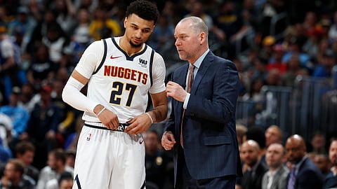 Denver Nuggets head coach Michael Malone, right, confers with guard Jamal Murray.