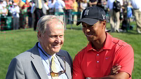 FILE - In this June 3, 2012, file photo, Jack Nicklaus, left, talks with Tiger Woods after Woods won the Memorial golf tournament at the Muirfield Village Golf Club in Dublin, Ohio. Winning his 15th major has renewed the conversation of whether he can catch the record held by Nicklaus. (AP Photo/Tony Dejak, File)