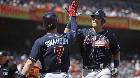 Braves’ Austin Riley (right) celebrates his eighth-inning home run with teammate Dansby Swanson on May 23 (Ben Margot)
