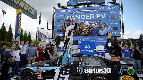 Driver Martin Truex Jr. (19) celebrates in victory lane after winning the NASCAR Cup Series auto race, Monday, May 6, 2019, at Dover International Speedway. He was doubly excited that Mark Eckel had him as one of his picks, (AP Photo/Will Newton)