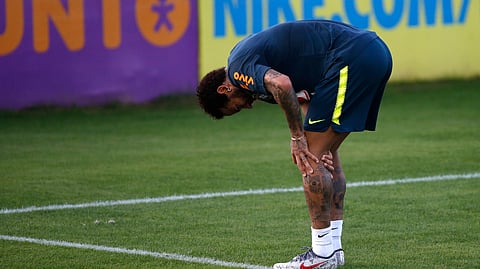 Brazil’s soccer player Neymar touches his left knee during a practice session at the Granja Comary training center ahead of the Copa America tournament, in Teresopolis, Brazil, Tuesday, May 28, 2019. (AP Photo/Leo Correa)