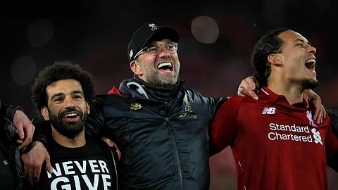 Liverpool’s Mohamed Salah, left, manager Jurgen Klopp, center, and Virgil van Dijk celebrate after the Champions League Semi Final, second leg soccer match between Liverpool and Barcelona on May 7, 2019. 