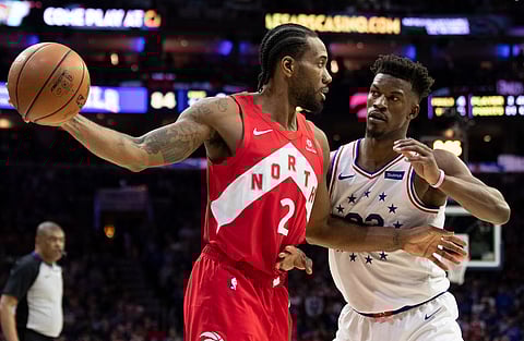 Toronto Raptors’ Kawhi Leonard, left, holds the ball away from Philadelphia 76ers’ Jimmy Butler, right, during the second half of Game 4 of a second-round NBA basketball playoff series, Sunday, May 5, 2019, in Philadelphia. The Raptors won 101-96. (AP Photo/Chris Szagola)