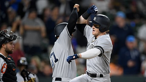 New York Yankees’ Clint Frazier, right, celebrates his three-run home run with Aaron Hicks, center, as Baltimore Orioles catcher Austin Wynns stands at left during the fifth inning of a baseball game Tuesday, May 21, 2019, in Baltimore. (AP Photo/Nick Wass)