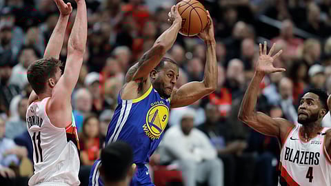 Golden State Warriors guard Andre Iguodala, center, is defended by Portland Trail Blazers forwards Meyers Leonard, left, and Maurice Harkless during the first half of Game 3 of the NBA basketball playoffs Western Conference finals Saturday, May 18, 2019, in Portland, Ore. (AP Photo/Ted S. Warren)