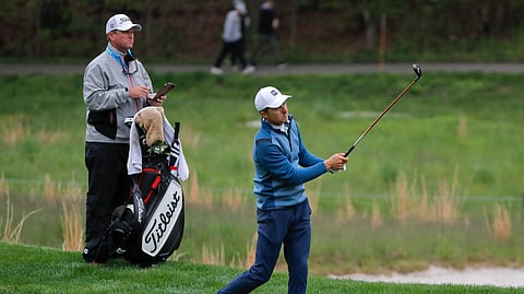 Jordan Spieth follows through on an approach shot on the fourth fairway during a practice round for the PGA Championship golf tournament on May 14, 2019.